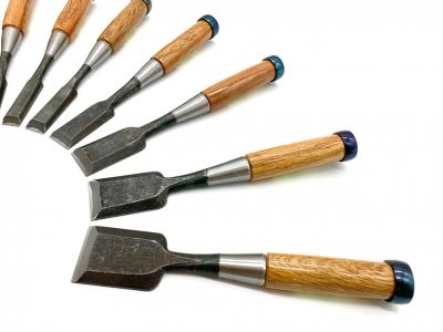 Chisels - Craftsman Supply (Collection of different sized chisels lined up in an arch shape row.)