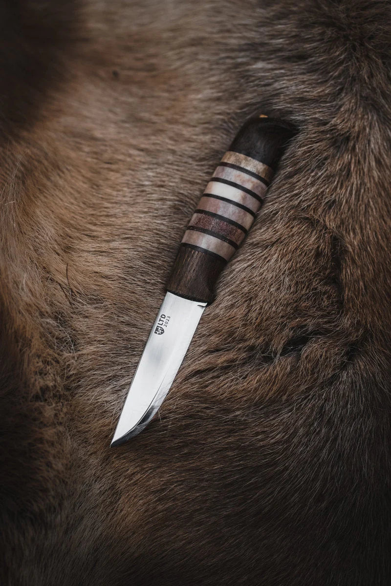 Helle Limited Edition 2023 Rein Knife against reindeer fur background
