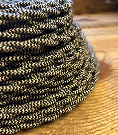 Cloth Covered Wire | Craftsman Supply Co. (Cloth covered wire that is finely coiled up on a wood surface)