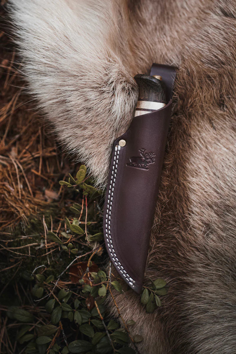 Helle Limited Edition Rein Knife in leather sheath on fur background